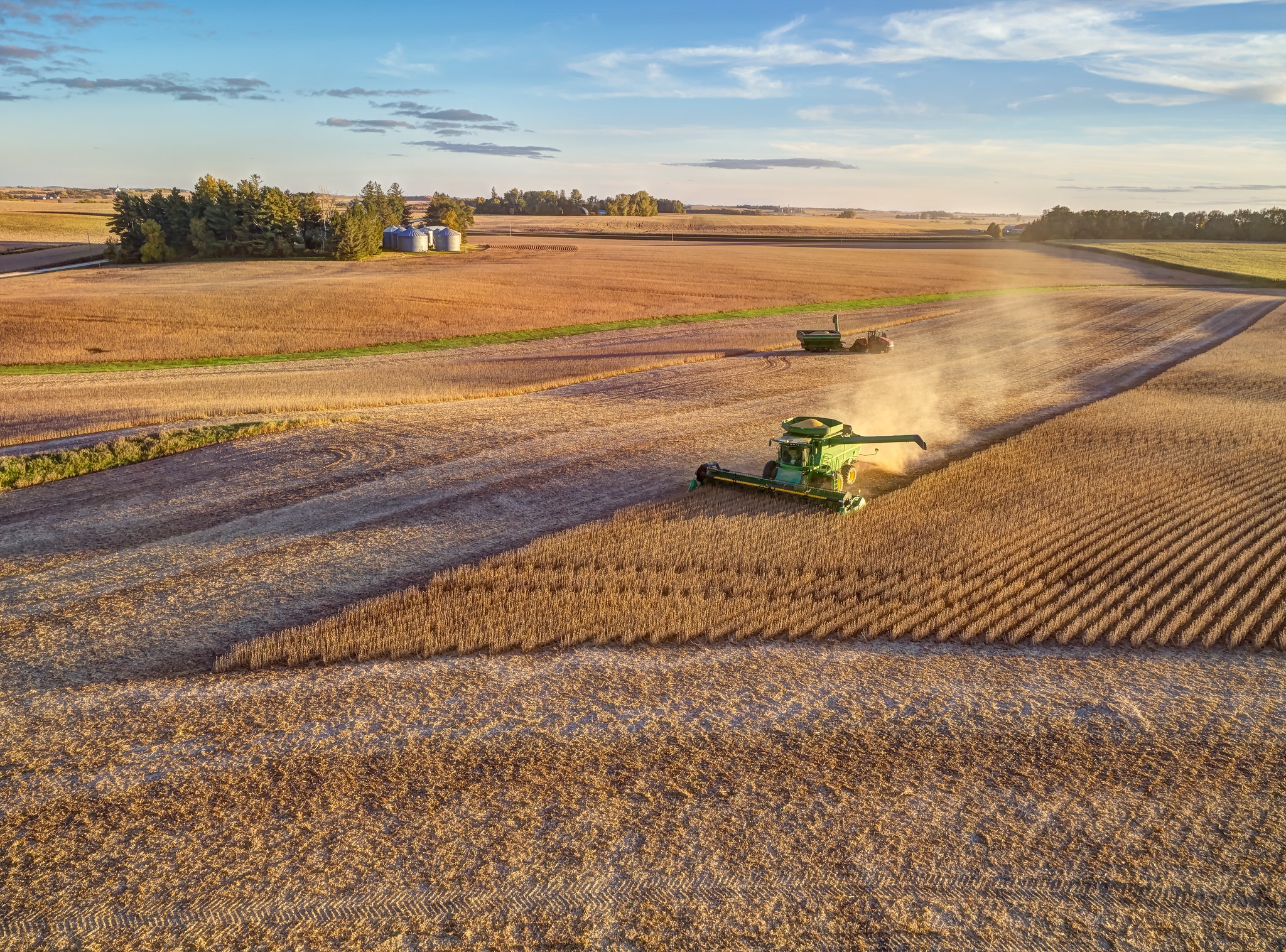 John Deere combine harvests a soybean field.